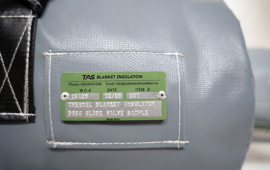 Metal embossed identification tag sewn onto industrial blanket and jacket insulation